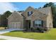 Charming home with brick and siding exterior, attached garage, and well-maintained lawn at 1124 Kingston Hill Dr, Loganville, GA 30052