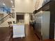 Open kitchen with stainless steel appliances, granite countertops, and dark wood cabinets at 1124 Kingston Hill Dr, Loganville, GA 30052