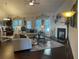 Inviting living room with hardwood floors, fireplace, and views into dining area and kitchen at 1124 Kingston Hill Dr, Loganville, GA 30052