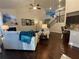 Inviting living room featuring a fireplace, fan, hardwood floors, and staircase at 1124 Kingston Hill Dr, Loganville, GA 30052