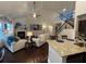 Open floor plan with living room and kitchen featuring fireplace and staircase at 1124 Kingston Hill Dr, Loganville, GA 30052