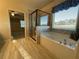 Modern bathroom featuring a soaking tub, glass shower, and neutral tile at 1124 Kingston Hill Dr, Loganville, GA 30052