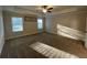 Spacious main bedroom with neutral carpet, a ceiling fan, and natural light at 1124 Kingston Hill Dr, Loganville, GA 30052