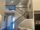 Grand staircase with dark metal railings leading to the upper level, showcasing open floor plan at 1124 Kingston Hill Dr, Loganville, GA 30052