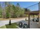 A covered patio area with air conditioning units and a wooded view offers a blend of comfort and nature at 161 Brush Creek Ct, Stockbridge, GA 30281