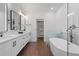 Bright bathroom features a freestanding tub, glass shower, double vanity and modern fixtures at 161 Brush Creek Ct, Stockbridge, GA 30281