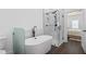 Soaking tub and glass shower highlight bathroom adjacent to bedroom in modern updated home at 161 Brush Creek Ct, Stockbridge, GA 30281