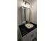 Stylish bathroom featuring a modern sink, black fixtures, and a sleek vanity with ample storage at 161 Brush Creek Ct, Stockbridge, GA 30281
