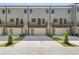 Modern townhome exterior featuring rear garages and balconies, set against a clear blue sky at 161 Brush Creek Ct, Stockbridge, GA 30281
