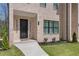 Close-up of a townhome's front door and exterior, highlighting brick facade and a welcoming entrance at 161 Brush Creek Ct, Stockbridge, GA 30281