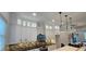 Expansive kitchen boasts sleek white cabinets, black hardware, modern lighting, and stainless steel appliances at 161 Brush Creek Ct, Stockbridge, GA 30281