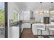 Kitchen with stainless steel appliances, white cabinets, island with bar seating and hardwood floors at 161 Brush Creek Ct, Stockbridge, GA 30281