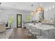 Modern kitchen featuring white cabinetry, stainless steel appliances, a breakfast bar and dark hardwood flooring at 161 Brush Creek Ct, Stockbridge, GA 30281