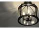 Close up of a modern glass and black metal three bulb ceiling light fixture at 161 Brush Creek Ct, Stockbridge, GA 30281