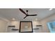 Living room featuring a modern ceiling fan, floating shelves and recessed lighting above the decorative fireplace at 161 Brush Creek Ct, Stockbridge, GA 30281