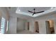Spacious main bedroom featuring tray ceiling with a ceiling fan, and ensuite bathroom, flooded with natural light at 161 Brush Creek Ct, Stockbridge, GA 30281