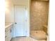 Bathroom featuring tiled shower, glass door, and white vanity with countertop at 1995 Catnap Ct, Chamblee, GA 30341