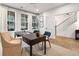 Bright home office with a desk, chair, and adjacent staircase at 1995 Catnap Ct, Chamblee, GA 30341