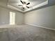 Large bedroom with ceiling fan and neutral wall colors at 5415 Rock Place Ct # 36, Norcross, GA 30093