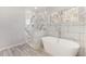 Elegant bathroom featuring a freestanding tub and a separate shower with marble-like tile surround at 508 Sutters Mill Rd, Stone Mountain, GA 30087