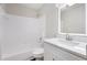 Clean, updated bathroom with modern vanity, illuminated mirror, and bathtub with white tile surround at 508 Sutters Mill Rd, Stone Mountain, GA 30087