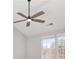 Ceiling fan with a light mounted to a white ceiling, below a set of windows and a light fixture at 508 Sutters Mill Rd, Stone Mountain, GA 30087