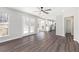 Open living room features hardwood floors, fireplace, and kitchen with stainless steel appliances at 508 Sutters Mill Rd, Stone Mountain, GA 30087