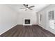 Living room with a ceiling fan, fireplace, hardwood floors, and glass paneled door to the backyard at 508 Sutters Mill Rd, Stone Mountain, GA 30087