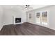 Spacious living room with hardwood floors, a fireplace, and glass paneled french doors to the yard at 508 Sutters Mill Rd, Stone Mountain, GA 30087