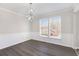 Dining room featuring hardwood floors, base molding and modern chandelier at 508 Sutters Mill Rd, Stone Mountain, GA 30087