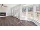 Bright living room featuring hardwood floors, a fireplace, and large windows with nature views at 508 Sutters Mill Rd, Stone Mountain, GA 30087