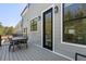 Relax on the spacious back deck with a table, chairs, and outdoor lighting at 165 Brush Creek Ct, Hampton, GA 30281