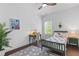 Cozy bedroom with a ceiling fan, a study desk, and natural lighting, creating an inviting personal space at 165 Brush Creek Ct, Hampton, GA 30281
