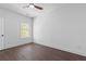 Bright bedroom featuring hardwood floors, a window with natural light, and clean white walls at 165 Brush Creek Ct, Hampton, GA 30281