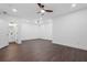 Large bedroom with wood-look flooring, ceiling fan, and ensuite bath access at 165 Brush Creek Ct, Hampton, GA 30281