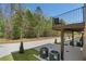 Back patio with greenery, a balcony, and AC units at 165 Brush Creek Ct, Hampton, GA 30281
