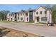Brick townhomes featuring manicured lawns and convenient street access at 165 Brush Creek Ct, Hampton, GA 30281