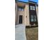 Stylish modern townhome with brick facade, dark accents, and a well-manicured lawn at 165 Brush Creek Ct, Hampton, GA 30281