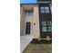 Modern home with brick and dark-colored siding, featuring a contemporary front door at 165 Brush Creek Ct, Hampton, GA 30281