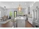 Modern kitchen featuring white cabinets, an island with seating, and stainless steel appliances at 165 Brush Creek Ct, Hampton, GA 30281