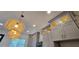 Kitchen with gray cabinets, glass door cabinets, and straw pendant lighting at 165 Brush Creek Ct, Hampton, GA 30281