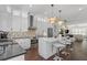Modern white kitchen featuring stainless steel appliances, a center island, and pendant lighting at 165 Brush Creek Ct, Hampton, GA 30281