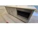 Kitchen island with white countertop, drawers and cabinets, and built-in microwave at 165 Brush Creek Ct, Hampton, GA 30281