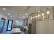 Well-lit kitchen featuring a quartz island, stainless appliances, and modern pendant lighting at 165 Brush Creek Ct, Hampton, GA 30281