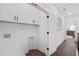 Convenient laundry area with white cabinets, offering storage and functionality at 165 Brush Creek Ct, Hampton, GA 30281