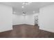 Spacious living room featuring wood floors, ceiling fan, and modern lighting at 165 Brush Creek Ct, Hampton, GA 30281
