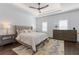 Luxurious main bedroom with tray ceiling, carpet, a ceiling fan, and plush bedding for a relaxing retreat at 165 Brush Creek Ct, Hampton, GA 30281