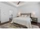 Bright main bedroom featuring a tray ceiling, ceiling fan, and ensuite bath access at 165 Brush Creek Ct, Hampton, GA 30281