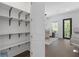 Walk-in pantry with adjustable shelving, located near a dining area and outdoor access at 165 Brush Creek Ct, Hampton, GA 30281
