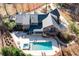 An aerial view shows the home's pool, screened porch, patio, and outdoor seating spaces at 355 Clark Creek Pass, Acworth, GA 30102